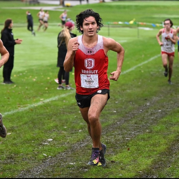 Rodrigo Alvarez Gonzalez running through mud during a cross-country event.