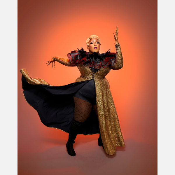 Man dressed as woman in makeup and long flowing coat