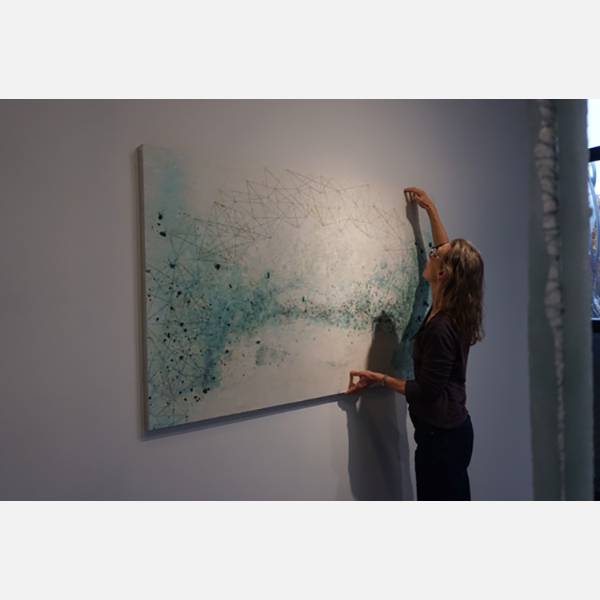 Lisa Nelson Raabe with her artwork.
