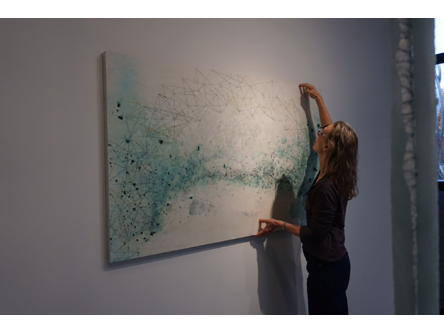 Lisa Nelson Raabe with her artwork.