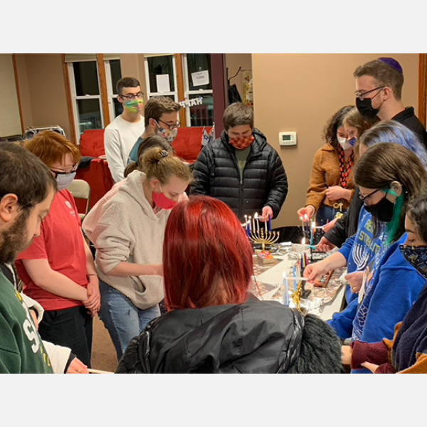 Bradley Jewish students light Menorah candles.