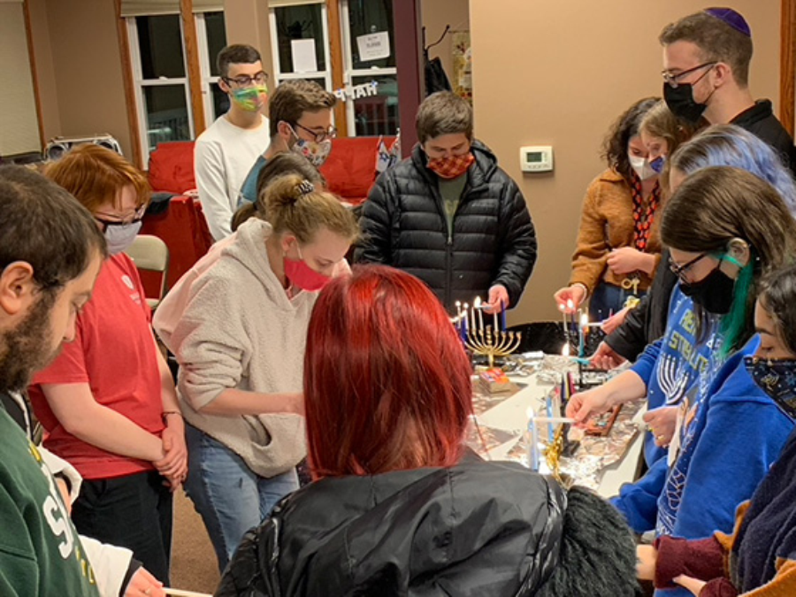 Bradley Jewish students light Menorah candles.