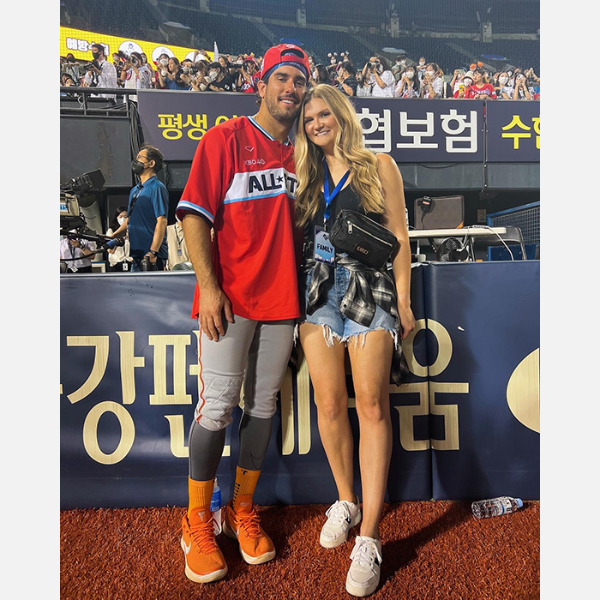 Photo of Mike and Eileen Ristau Tauchman together before the baseball game standing in front of the the media booth.
