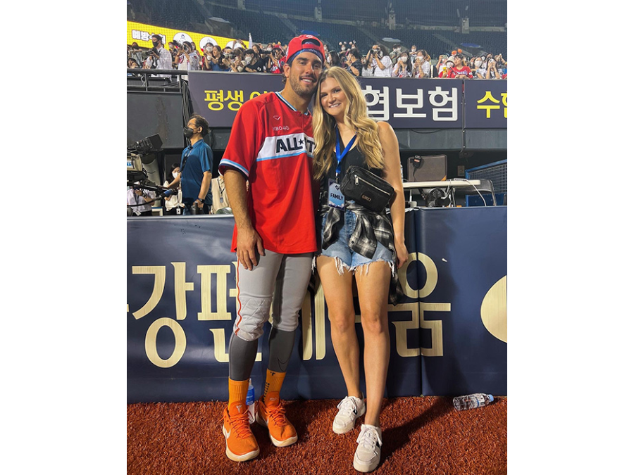 Photo of Mike and Eileen Ristau Tauchman together before the baseball game standing in front of the the media booth.