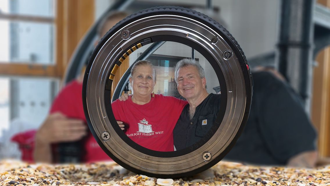 Sheila Consaul ’80 and Rich Russo ’84 pose behind the lens of a camera