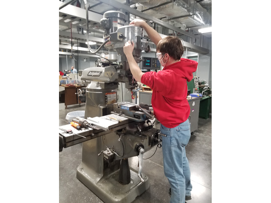 Bradley student creating parts in a machine shop for the robot.