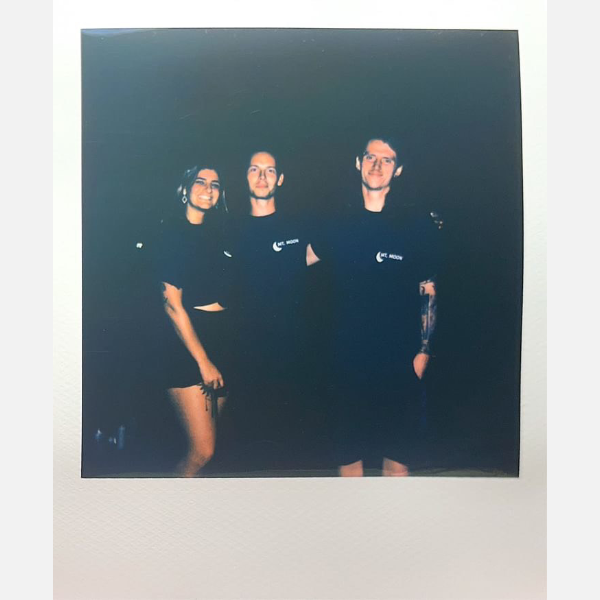 Jonathan Vota and his fellow Mt. Moon volunteers pose for a polaroid after a hard day hosting Mt. Moon Fest