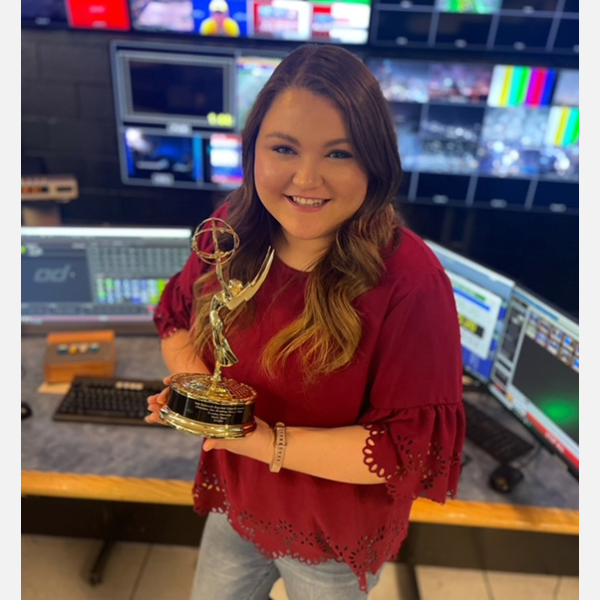 Molly Horst ‘15 holding her Emmy award