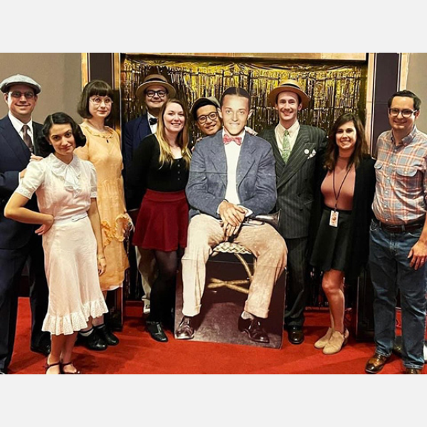 Dancers posing with a cut out of Leon “Bix” Beiderbecke