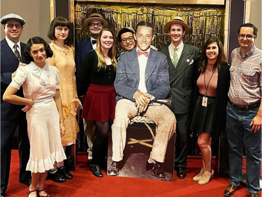 Dancers posing with a cut out of Leon “Bix” Beiderbecke