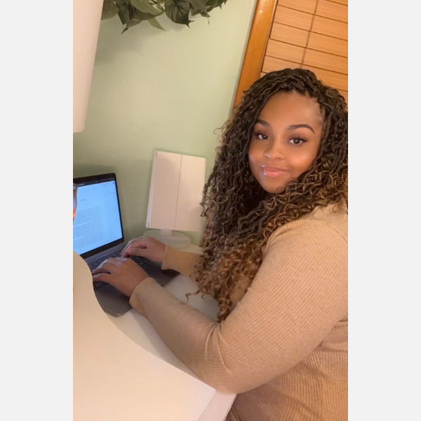 Danyelle Butler sitting in front of her laptop