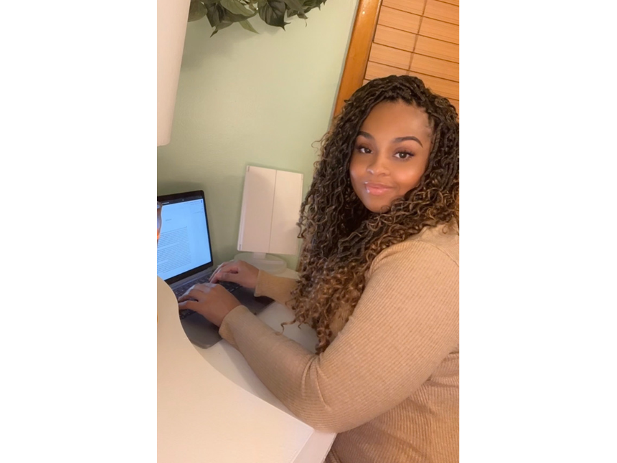 Danyelle Butler sitting in front of her laptop