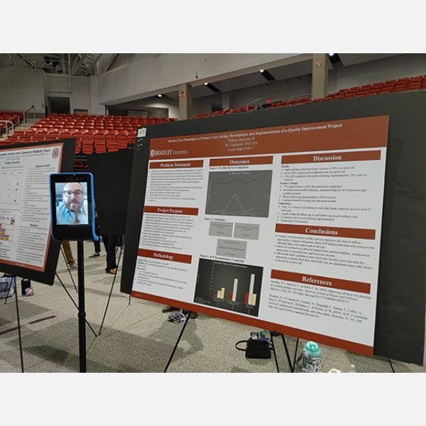 Wil Beachum with his capstone project poster.