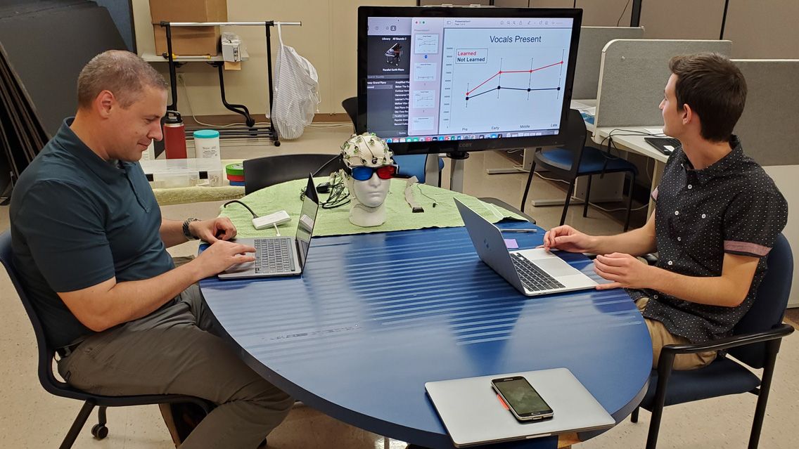 Seth Metcalfe looking at a graph on a tv monitor.